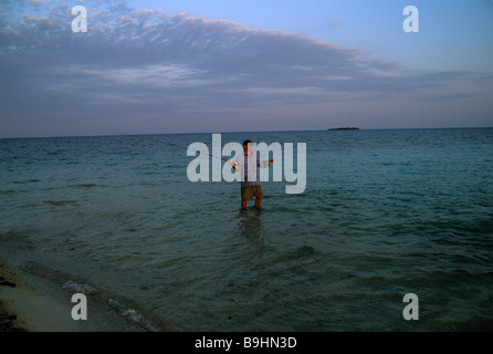 a fly fisherman casts to Bonefish in Belize Stock Photo