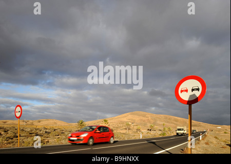 Cars on a road and no overtaking sign in Fuerteventura, Canary Islands, Spain, Europe Stock Photo