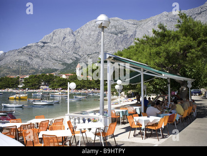 Croatia Dalpatia Makarska Riviera Promajna beach restaurant boats Europe destination coast beach Biokovo mountains place church Stock Photo