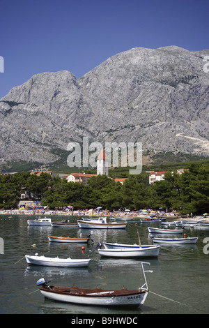 Croatia Dalpatia Makarska Riviera Promajna beach swimmers boats Europe destination coast beach Biokovo mountains place church Stock Photo