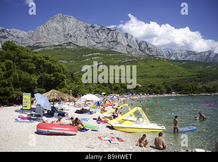 Croatia Dalpatia Makarska Riviera Promajna beach swimmers pedal boate Europe destination coast beach Biokovo mountains beach Stock Photo