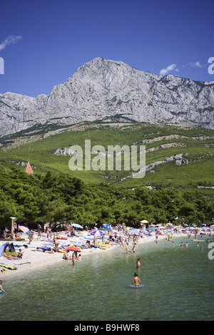 Croatia Dalpatia Makarska Riviera Promajna beach swimmers Europe destination coast beach Biokovo mountains beach people Stock Photo