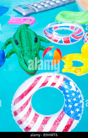 Air mattresses floating on swimming pool Stock Photo