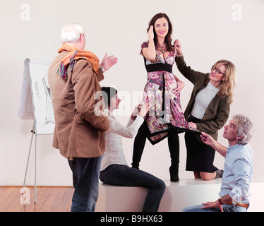 Fashion designers adjusting dress Stock Photo