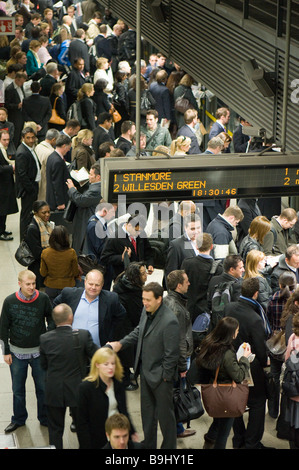 Commuters on crowded platform awaiting train Canary Wharf Docklands London United Kingdom Stock Photo