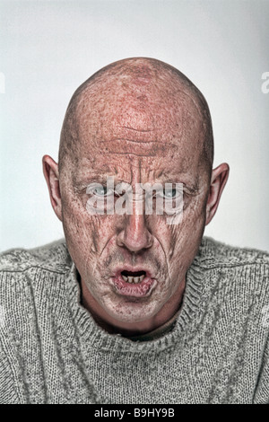 Studio shoot of angry bald man Stock Photo
