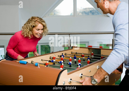 Couple having fun playing table football Stock Photo
