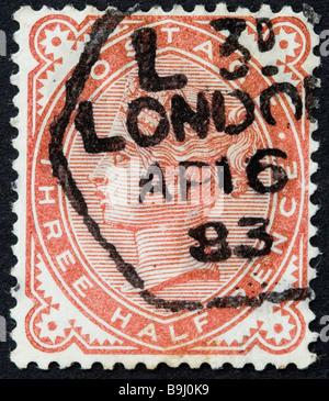 Close up of three halfpenny orange Victorian British Postal stamp on black background issued circa 1880 SG 167 used, postmarked London. Stock Photo