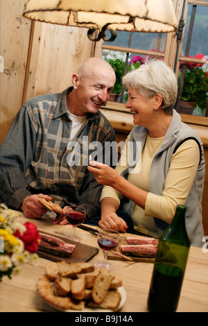 Couple at a Toerggelen, the custom of eating a meal with friends in the Province of Bolzano-Bozen during autumn Stock Photo