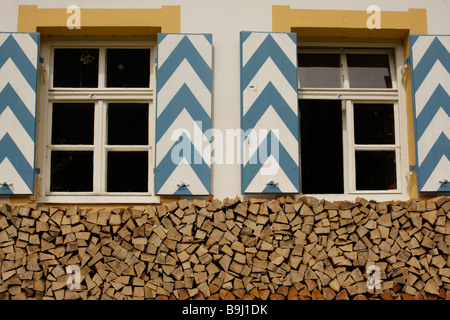 Bavarian house with wooden window shutters, firewood, Bavaria, Germany, Europe Stock Photo