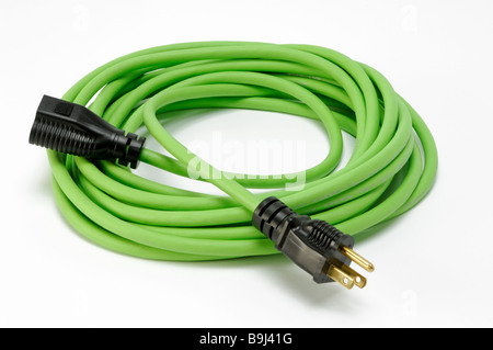 A coiled green electrical extension power cord with two plugs Stock Photo