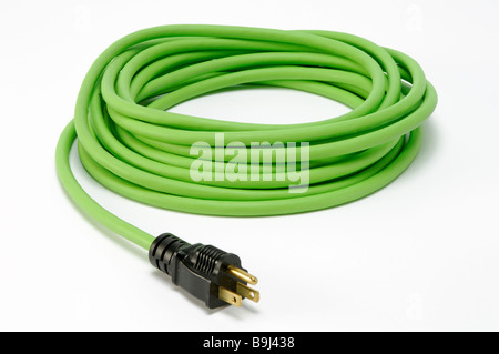 A coiled green electrical extension power cord with one plug Stock Photo