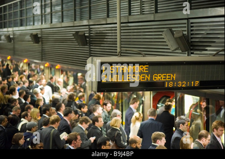 Commuters on crowded platform awaiting train Canary Wharf Docklands London United Kingdom Stock Photo