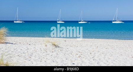 Boots anchored in front of dune beach of Porto Pino, Sardinia, Southern Coast, Italy, Europe Stock Photo