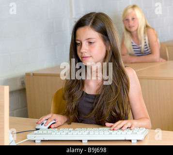 Girl, eleven years, learning on a PC Stock Photo