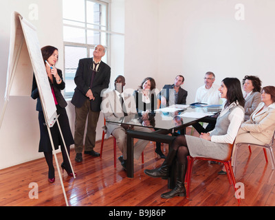 Co-workers giving presentation in office Stock Photo
