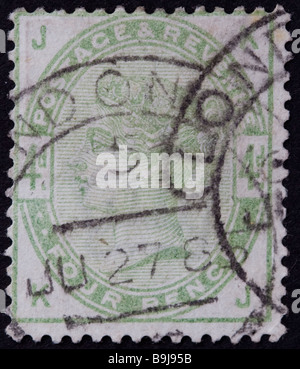 Close up of 4d, pale green Victorian British Postal stamp on black background. Issued between 1883-4 SG 192 Unified issue. Postmark, London. Stock Photo