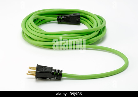 A coiled green electrical extension power cord with two plugs Stock Photo