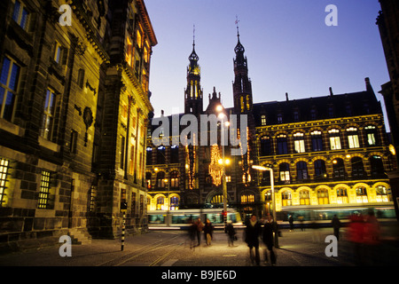 Magna Plaza, shopping mall in the former main post office building, lit-up facade in the evening, Nieuwezijds Voorburgwal, Amst Stock Photo