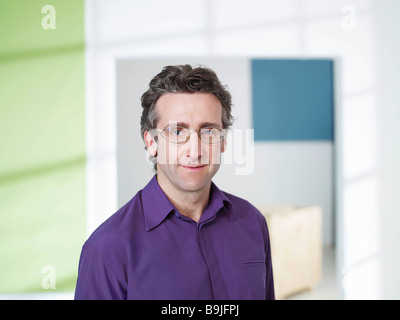 Business man standing in loft Stock Photo