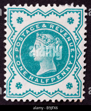 Close up of ½d, one half penny green Victorian British Postal stamp on black background issued between 1887-1900, part of the 'Jubilee Issue'. Unused. Stock Photo