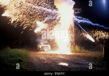 Transformer on hydro pole explodes in the night Stock Photo