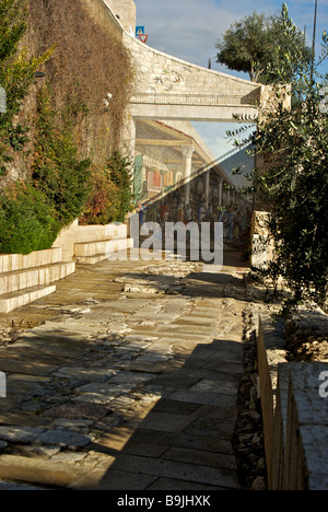 Mural of shoppers at an ancient agora painted on wall of the old Jerusalem city near Dung Gate Stock Photo