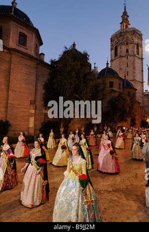 Falleras arrive on Plaza de la Virgen with flower offering for Virgen de los Desamparados. Las Fallas festival. Valencia. Spain Stock Photo