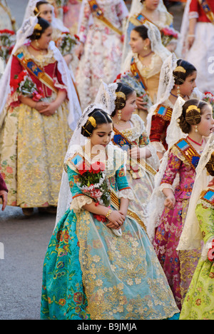 Young children Falleras parade towards Plaza de la Virgen with flower offerings. Las Fallas. Valencia Spain Stock Photo