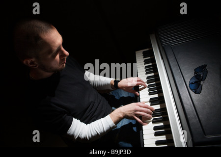 Pianist playing on electric piano Stock Photo