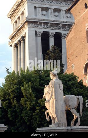 Italy, Lazio, Rome, statue of the Dioscuri on Piazza del Campidoglio with the Monument to Vittorio Emanuele II in the Stock Photo