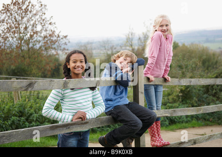 Children on fence Stock Photo