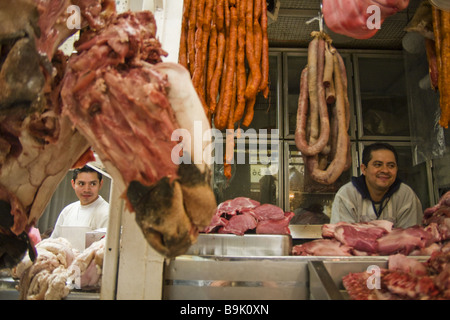 Butchers wait for customers from their stalls at La Merced market in Mexico City, Mexico. Stock Photo