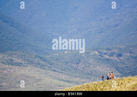 A family walks through the foothills of the Sierra Norte Mountains, Oaxaca, Mexico. Stock Photo