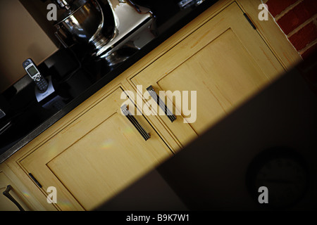 Kitchen unit with gloss black work surface. Stock Photo
