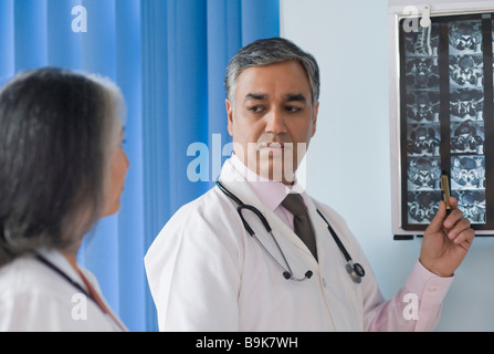 Two doctors examining an x-ray report Stock Photo