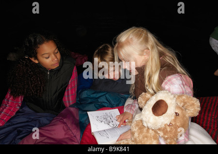 Children reading in tent Stock Photo