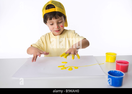 Little boy is making a finger painting Stock Photo