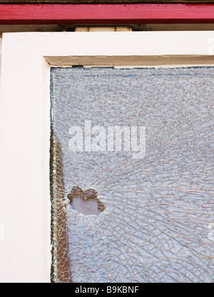 A smashed double glazed window caused by vandalism. Stock Photo