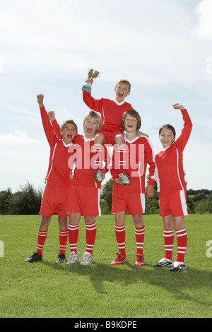 Football team holding trophy Stock Photo