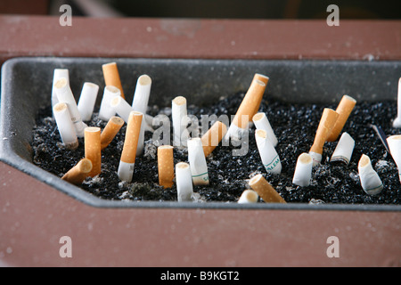 Cigarette butts in ashtray smoking nicotine cigar Stock Photo