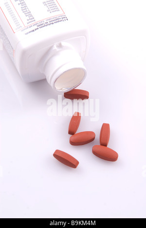 Multivitamin bottle and pills isolated against a white background Stock Photo