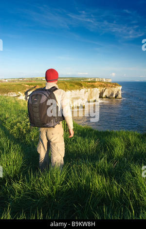 A visitor enjoying the view from the cliff tops on the Flamborough Headland Heritage Coast East Riding of Yorkshire Stock Photo