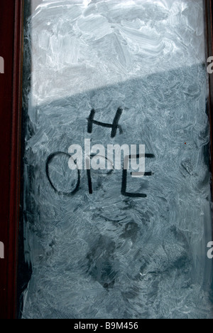 the word hope handwritten on a whitewashed shop window Stock Photo