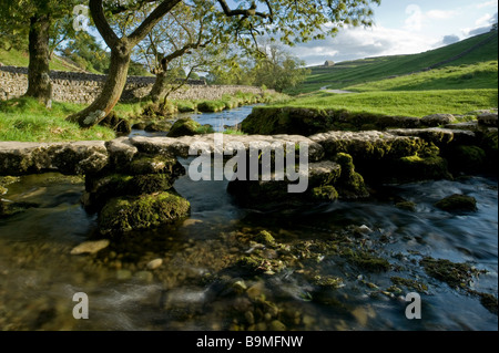 Clapper bridge over Malham Beck, Malham Cove, North Yorkshire. Stock Photo