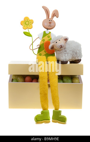 Easter bunny on a box full of easter eggs isolated on white Stock Photo