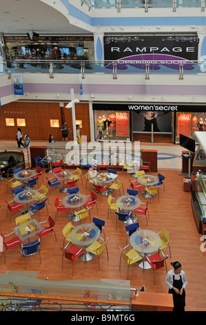 Abu Dhabi Marina shopping mall interior dining area at breakfast time with tables and chairs with shops beyond Stock Photo