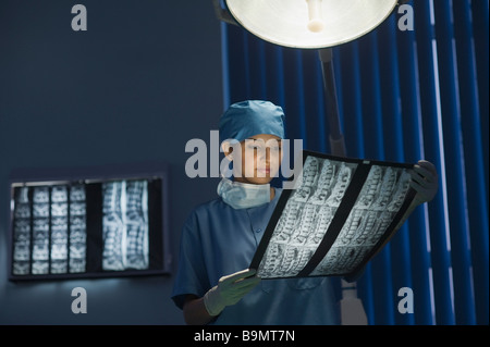 Female doctor examining an x-ray report Stock Photo