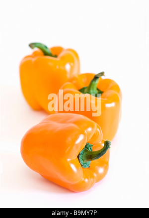 Closeup of three orange peppers Stock Photo