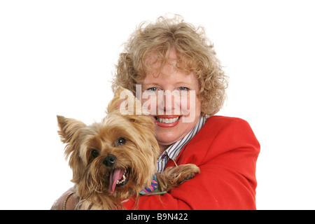 A pretty red haired woman holding her adorable pet yorkshire terrier  Stock Photo